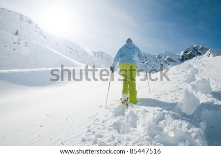 Snowshoeing - woman trekking in winter mountains (copy space)
