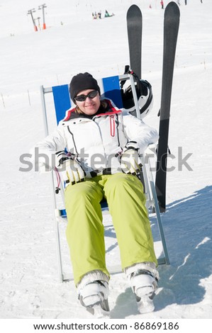 Skiing, winter holiday - portrait of female skier resting in ski resort