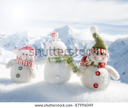 Winter, holiday - Happy snowman friends in mountains