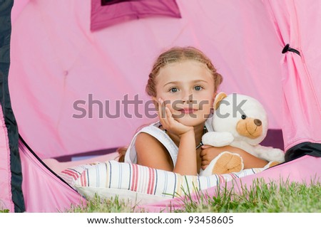 Camping in tent - cute girl on camp tent