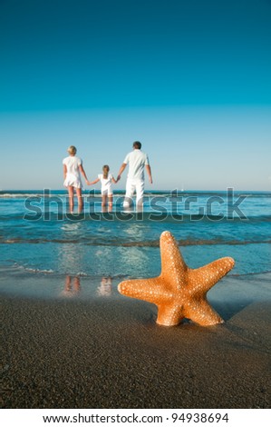 Summer vacation -  family on the beach (space for text)