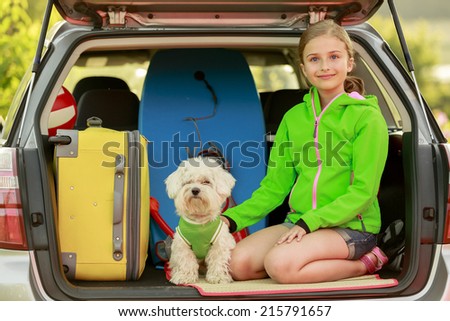 Travel - girl with dog ready for the travel for  vacation