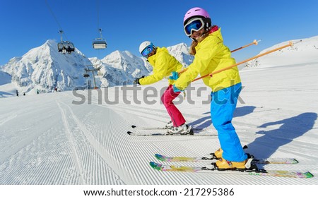 Skiing, winter sport, ski lesson - happy skiers on mountainside