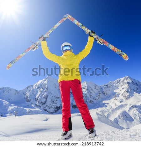 Ski, skier, sun and winter fun - woman enjoying ski vacation