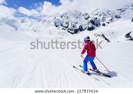 Skiing, winter sport - child skiing downhill