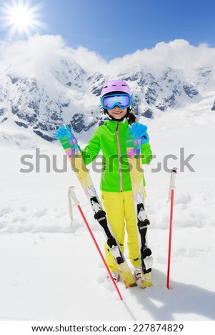 Ski, winter fun - lovely skier girl enjoying ski vacation