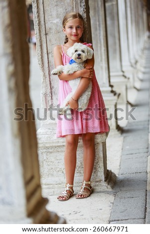 Happy Young Girl with her Dog in the City Venice, Italy. Youth Lifestyle Concept