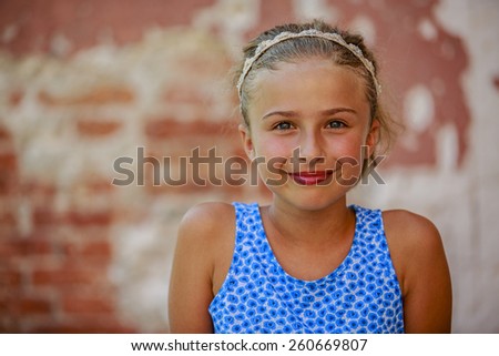 Happy beautiful young girl in summer dress posing joyful and cheerful smiling in Venice, Italy.