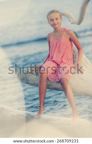 Summer vacation, portrait of lovely fashion young girl on the beach-filtered, backlight image