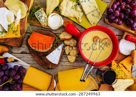 Cheese -  foundue on a wooden table, different types of cheese