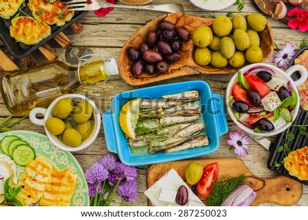 Greek cuisine dishes - feta, choriatiki, halloumi, tzatziki, sardines