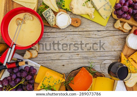Cheese, fondue cheese - different types of cheese on a wooden background