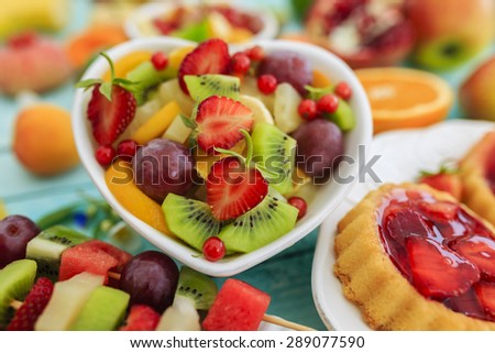Healthy fruit salad, fruit skewer, strawberry tart - summer party