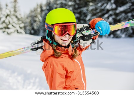 Ski, winter vacation, snow, skier, sun and fun - girl enjoying ski vacations