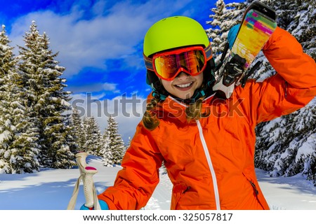 Ski, winter vacation, snow, skier, sun and fun - girl enjoying ski vacations
