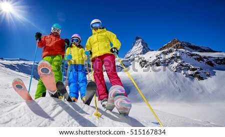 Skiing, winter, snow, sun and fun - family enjoying winter vacations in Zermatt, Switzerland.