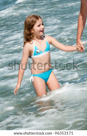 Summer vacation - lovely  girl wading in the sea
