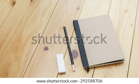 Loft business workspace with stationery on wooden table.