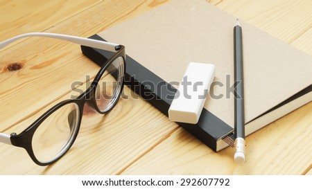 Loft business workspace with stationery on wooden table.