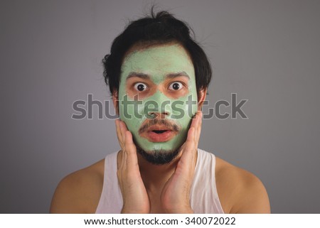 Asian man with face mask skincare.