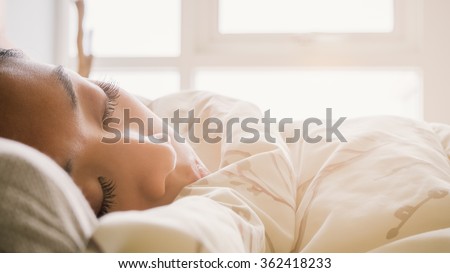 Asian woman sleeping on the bed.