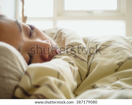 Asian woman deep sleeping on the bed.