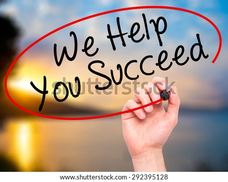 Man Hand writing We Help You Succeed with black marker on visual screen. Isolated on nature. Business, technology, internet concept. Stock Image