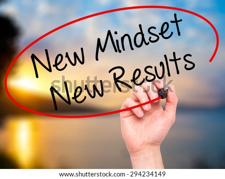 Man Hand writing New Mindset New Results with black marker on visual screen. Isolated on nature. Business, technology, internet concept. Stock Photo