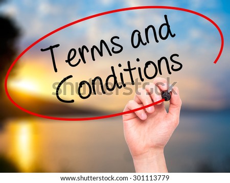 Man Hand writing Terms and Conditions with black marker on visual screen. Isolated on nature. Business, technology, internet concept. Stock Photo
