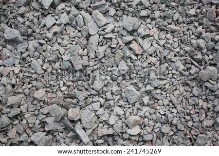 A close up of rocky gravel stones - background made of a closeup of a pile of crushed stone