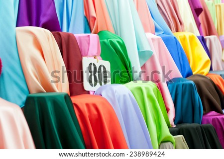 Rolls of textile, cloth and tissue of various colors on the market