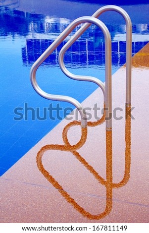Pool ladder and swimming pool.