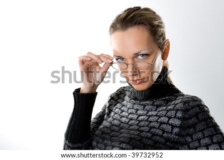 Serious woman looking over glasses