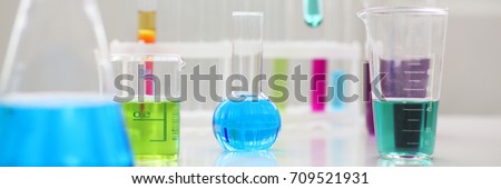 Chemical industry bulb with blue magenta pink liquid lab tubes stand on the table in the laboratory of liquid testing test development substances poisons additives stabilizers flavors house cleaning