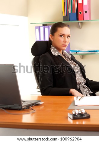 Business woman sitting in the office in front of the laptop