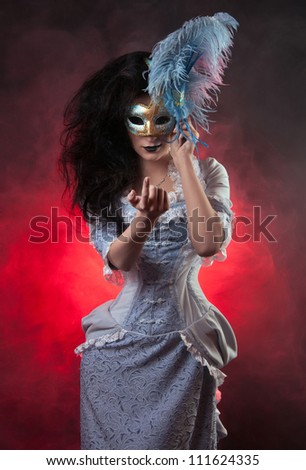 Beautiful Halloween vampire woman aristocrat with venetian mask