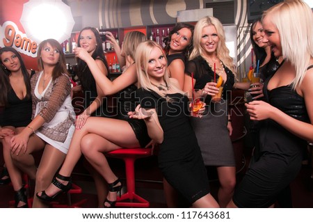 Girls company having fun in the night club