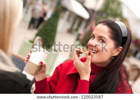 Two young women having coffee break together