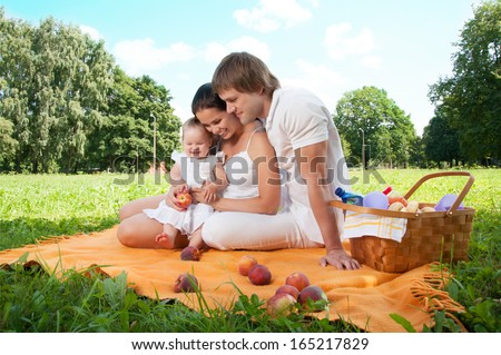 Happy Family Picnicking In The Park