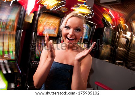 Young Woman In Casino On A Slot Machine