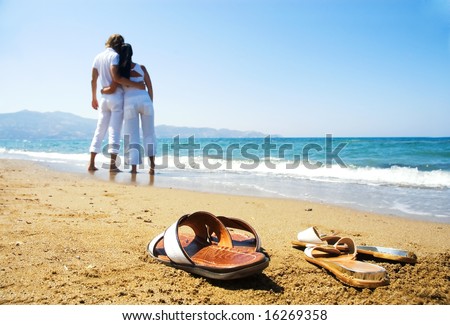 stock photo Young attractive couple at the beach focused front view 