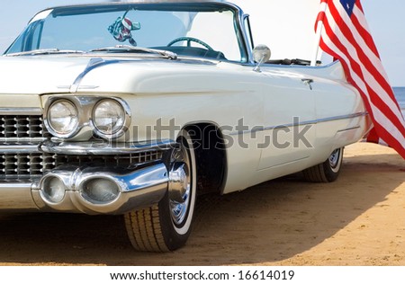 stock photo Classic white Cadillac at the beach with American flag