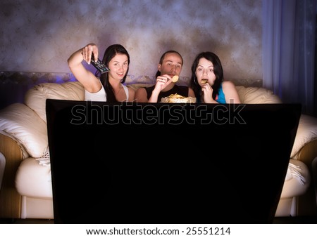 Three friends are watching TV