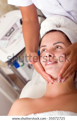 Young woman getting skin cleaning at beauty salon (shallow dof)