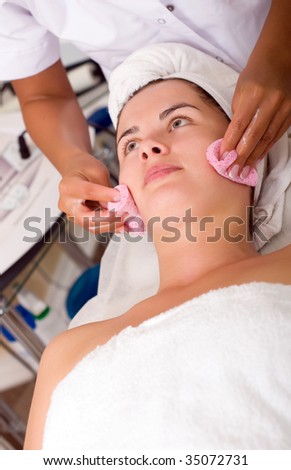 Young woman getting skin cleaning at beauty salon (shallow dof)