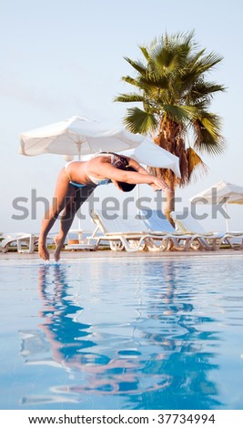 Woman jumping into the pool