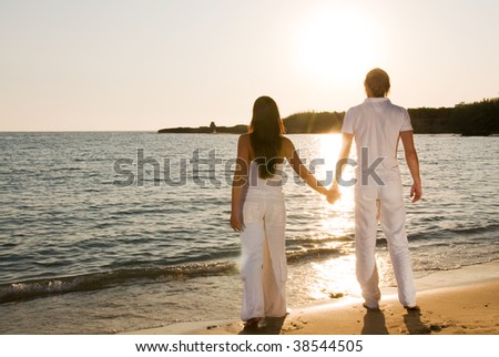 Couple hugging, enjoying summer sunset.