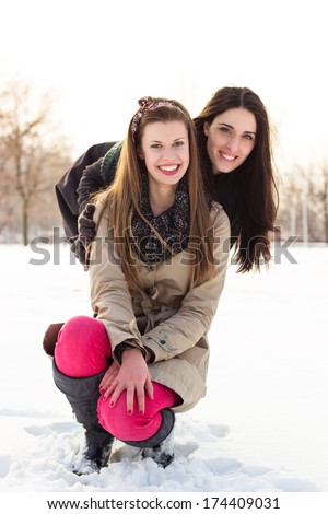 Friendly hug. Two best friends hugging in the snow