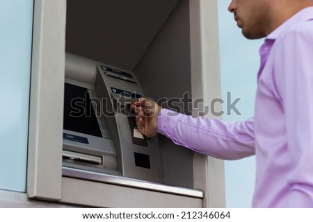 Inserting card into cash dispenser