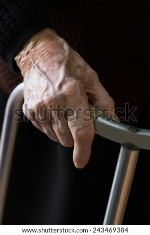 Grandmother hands using a walker as support